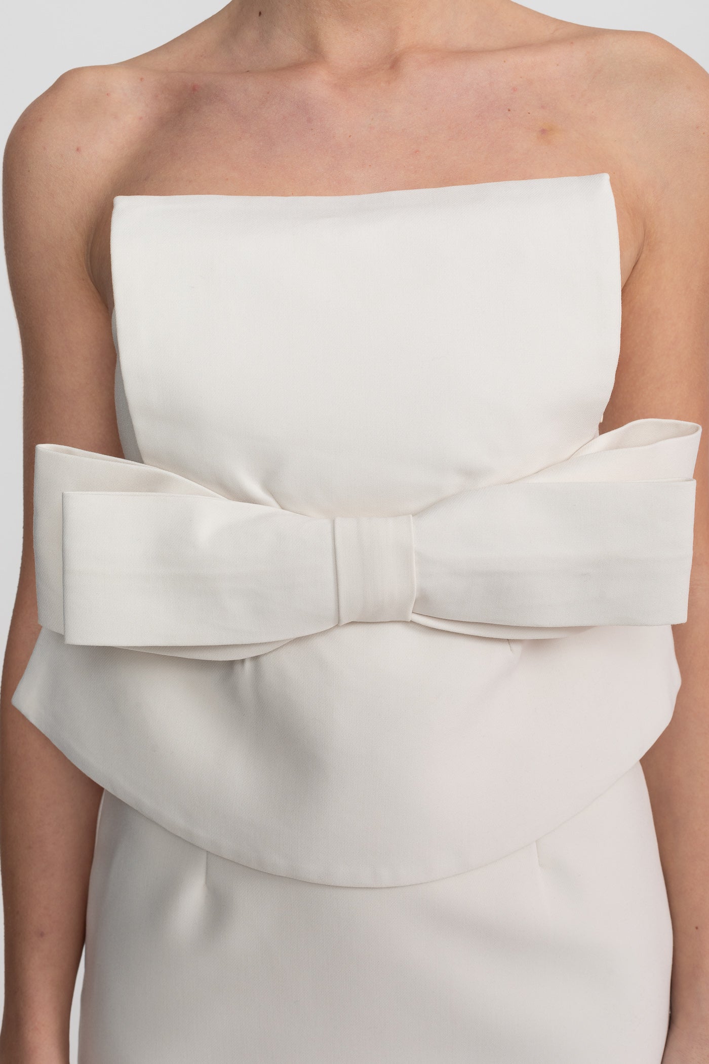 Strapless Mini Dress With Oversized Bow Waist And Peplum Overlay - White