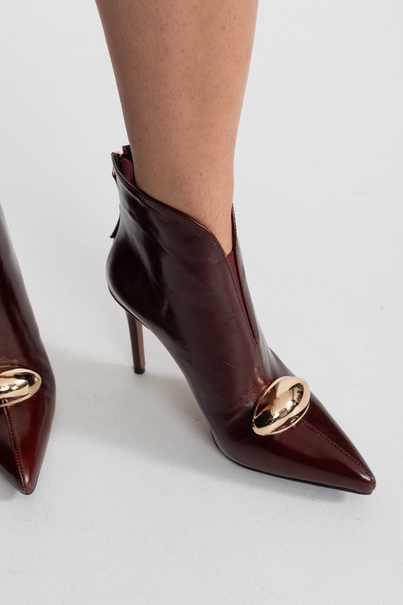 Leather Pointed-Toe Ankle Boots with Gold Buckle Detail – Burgundy