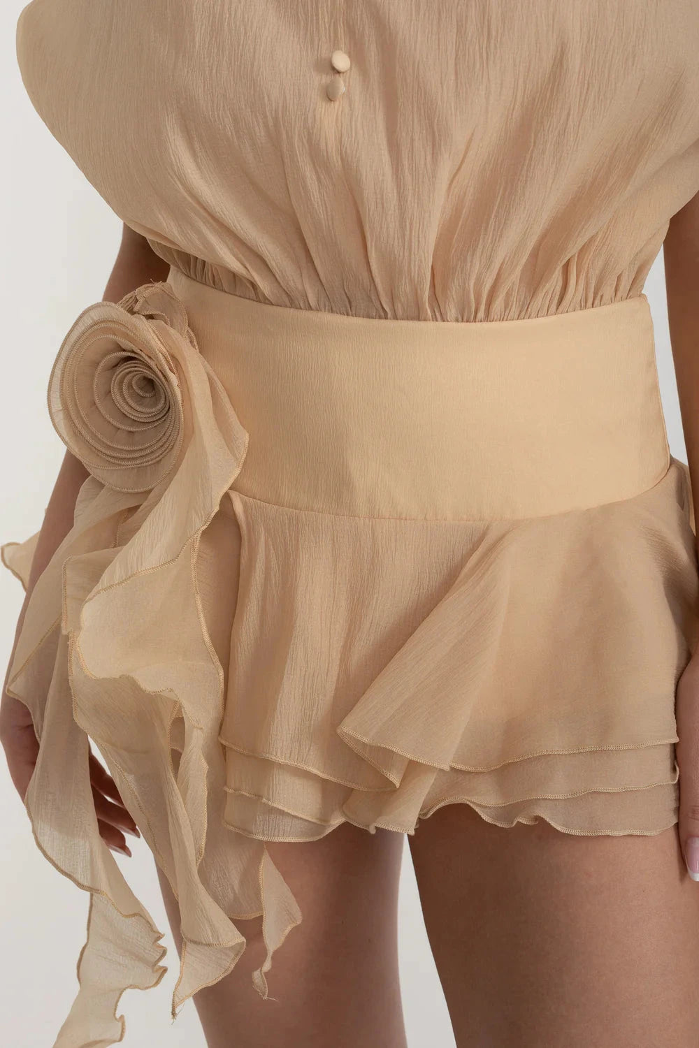 Elegant Mini Dress With Peplum Hem And Rosette Waist Embellishment - Beige